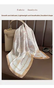 Close-up of printed silk square scarf draped on a leather handbag in earth tones