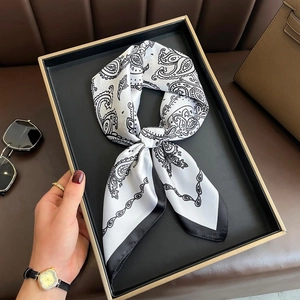 Elegant white paisley silk scarf with black contrast border in luxury gift packaging