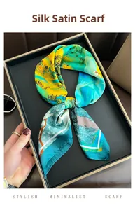 Close-up of a satin square scarf with artistic landscape print and green silk texture