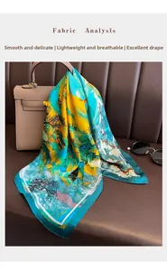 Detail of silk-textured scarf with floral print draped elegantly on a designer handbag