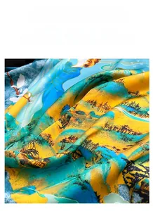 Detailed close-up of glossy satin silk scarf with artistic landscape print and soft folds