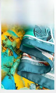 Detail shot of the hand-stitched hem on the colorful silk square scarf for women