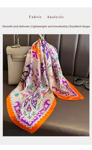 Detail of paisley print silk scarf showing smooth texture and vibrant orange border