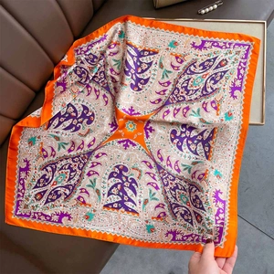 Orange Paisley silk-like square scarf with bohemian print on brown leather background
