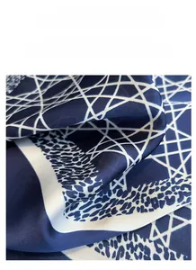 Macro detail of navy blue silk scarf with geometric lines and leopard print texture