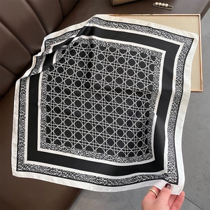 Detail of silk-like square scarf with black and white geometric lines and leopard print