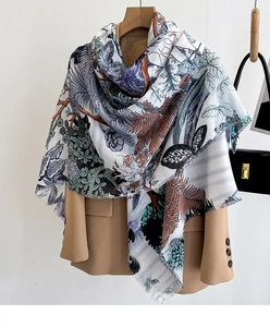Close-up of elegant floral print scarf with soft fringe edges over a khaki blazer