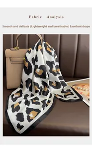 Detail of leopard print silk scarf draped over a brown bag showing its elegant drape