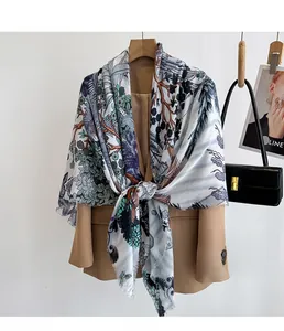 Detail of silk texture floral printed shawl with fringed edges on a beige blazer