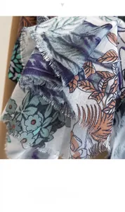 Macro detail of elegant vintage floral print scarf with soft frayed fringe edges