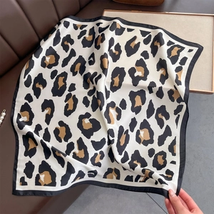 Classic leopard print silk-feel square scarf with black borders on leather background
