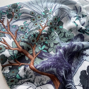 Detailed close-up of premium silk scarf featuring elegant botanical prints and fine texture