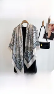 Close-up of elegant paisley print scarf draped on black clothing for styling