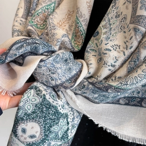 Close-up of bohemian paisley printed shawl with elegant fringe edges in vintage tones