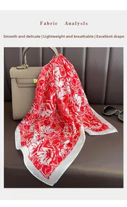 Detail of red and white floral silk scarf with smooth, breathable and glossy texture