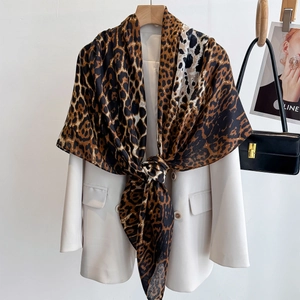 Leopard print silk scarf shawl styled over white blazer for a stylish urban look