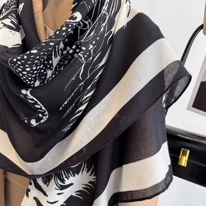 Minimalist black and white leopard print large square scarf worn as a stylish shawl wrap