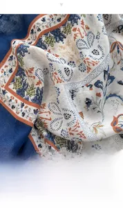 Close-up of lightweight floral cotton-linen shawl with navy and orange paisley patterns