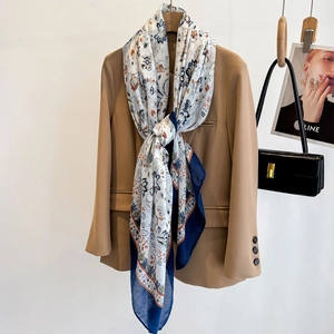 Floral paisley print shawl draped over a khaki blazer for elegant autumn styling