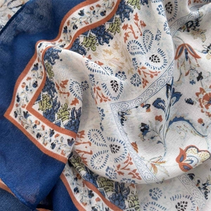 Macro detail of breathable cotton-linen scarf with intricate paisley and floral patterns
