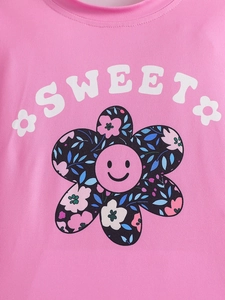 Detail of pink cotton T-shirt featuring a floral smiley sunflower and Sweet text print
