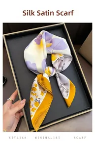 Detail of silk-like satin square scarf with purple floral print and gold border
