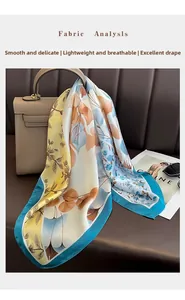 Detail of floral faux silk square scarf tied on a handbag showing smooth satin texture