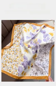 Detail of floral silk satin square scarf with orange borders and printed patterns