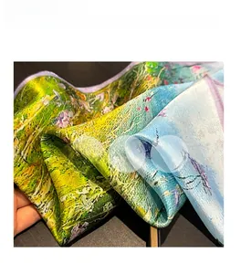Close-up of lightweight silk scarf showing sheer texture and artistic oil painting pattern