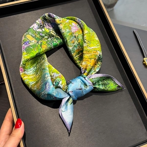 Artistic oil painting silk scarf with vibrant colors displayed in a luxury jewelry tray