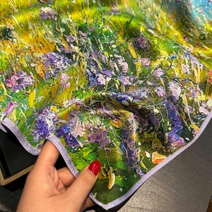 Detailed close-up of 100% mulberry silk scarf with oil painting floral pattern and lilac piping