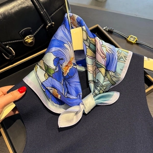 Silk floral square scarf with blue iris print paired with leather bag and watch