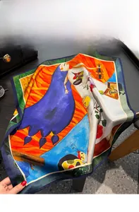 Detail of silk square scarf featuring retro artistic prints and smooth fabric texture