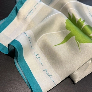 Elegant silver grey silk square scarf with vibrant green floral print and blue borders