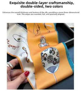 Close-up of double-sided silk scarf with orange and beige floral patterns and fine stitching