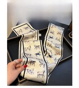Macro detail of silk skinny scarf with classic equestrian horse print and black border