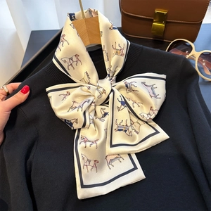 Elegant skinny silk scarf with colorful horse print tied on a black knit sweater