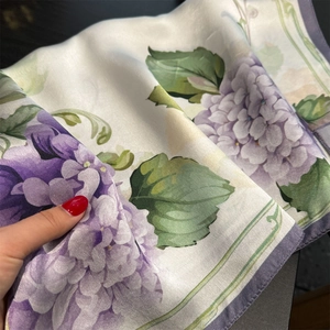 Detailed close-up of 100% mulberry silk scarf featuring purple hydrangea floral pattern
