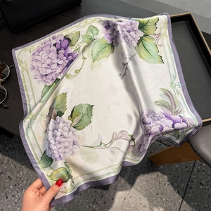 Close-up of silk square scarf featuring realistic purple hydrangea and green leaf prints