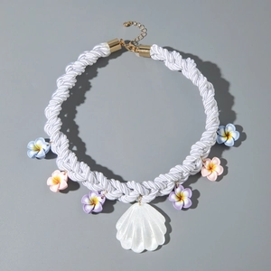 Detail of woven ocean necklace with colorful flowers and white shell pendant