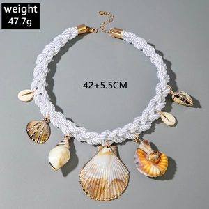 Detail of seashell pendants with golden metal edges on a white braided cord necklace