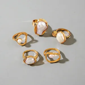 Detailed set of five gold-plated branch rings with irregular baroque pearls and floral accents