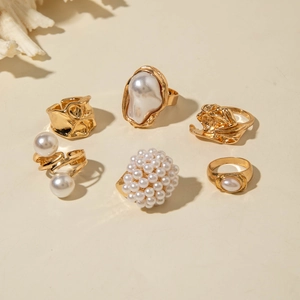 Detailed view of a 6-piece vintage gold alloy ring set with baroque and small pearls