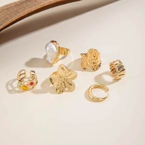 Detailed view of 6-piece gold alloy ring set with Baroque pearls and colorful gemstones