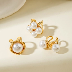 Detailed view of luxury gold alloy earring set with white pearls in flower branch designs