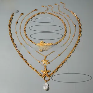 Detail of layered gold starfish flower necklace set with baroque pearl and weight info