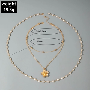 Detail of layered gold starfish flower necklace with pearls showing length measurements
