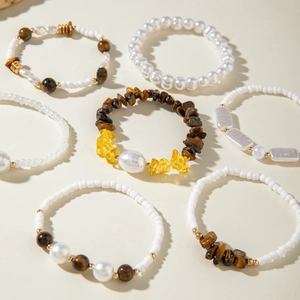 Detail of seven Bohemian style beaded bracelets with pearls and tiger eye stones