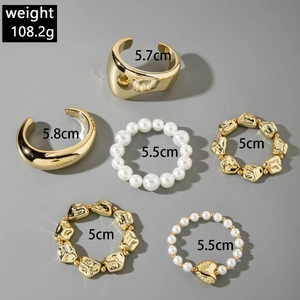 Detail view of 6-piece gold metal bangle and pearl bracelet set with diameter specs