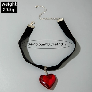 Detail view of gothic velvet choker with red glass heart pendant and silver lobster clasp